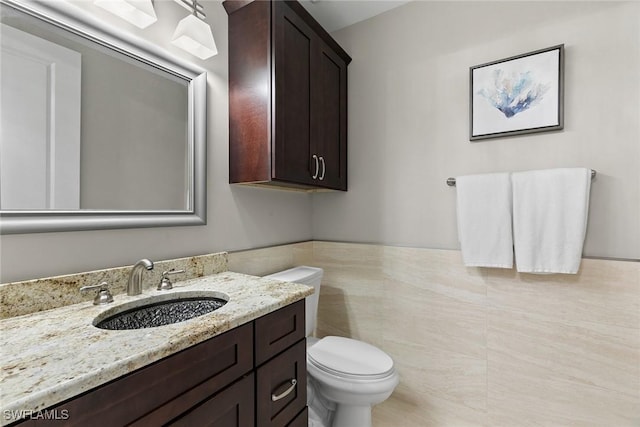 bathroom featuring tile patterned flooring, vanity, and toilet