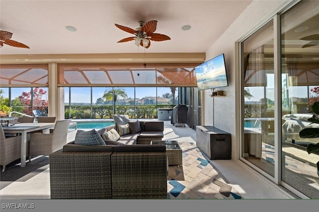 sunroom featuring ceiling fan