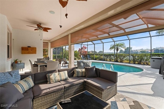 outdoor pool with a ceiling fan, a lanai, a patio, and an outdoor living space