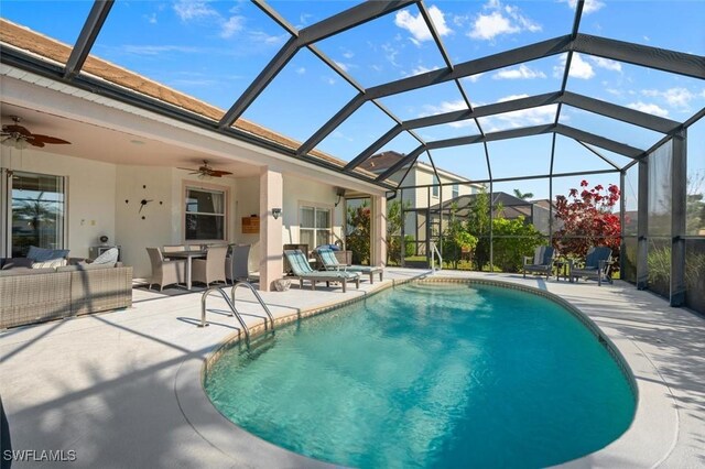 view of swimming pool with a lanai, ceiling fan, and a patio