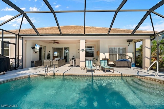 back of property featuring glass enclosure, ceiling fan, a patio area, and a pool with hot tub