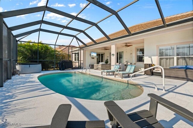 view of pool featuring ceiling fan, a patio area, a lanai, and a grill