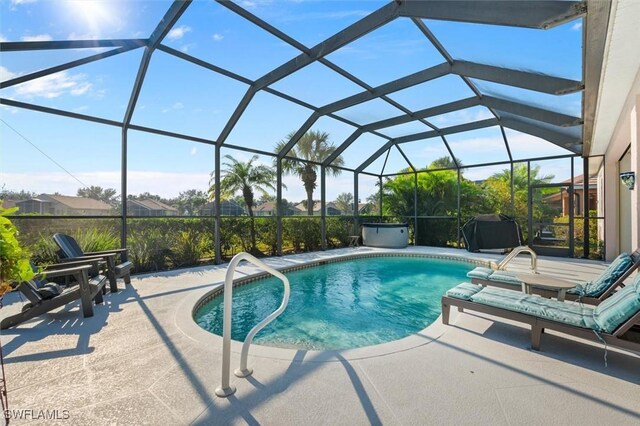 view of swimming pool with a lanai and a patio area