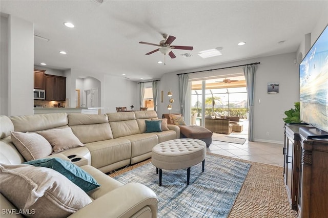 living room featuring light tile patterned floors and ceiling fan