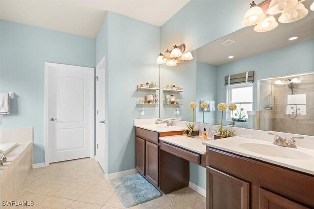 bathroom with plus walk in shower, vanity, and tile patterned floors