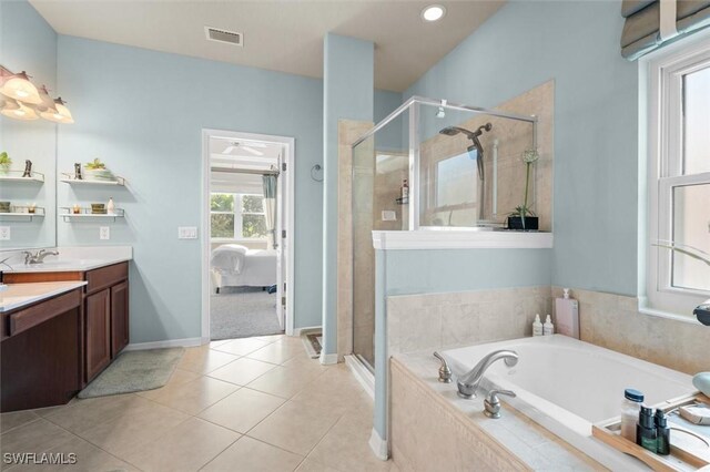 bathroom featuring tile patterned floors, vanity, and plus walk in shower