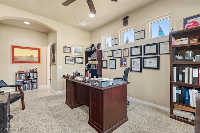 carpeted office space with ceiling fan