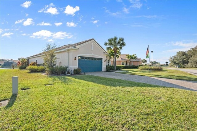 single story home with a garage and a front lawn