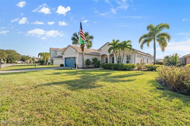 view of front of property featuring a front yard and a garage