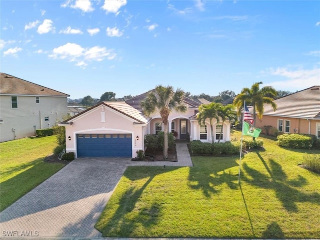 3259 Hampton Blvd, Alva, FL 33920 - mediterranean / spanish-style house featuring stucco siding, decorative driveway, an attached garage, and a front lawn