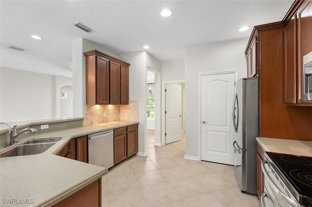 3259 Hampton Blvd, Alva, FL 33920 - kitchen with stainless steel appliances, light countertops, tasteful backsplash, recessed lighting, and arched walkways