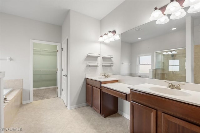 3259 Hampton Blvd, Alva, FL 33920 - bathroom featuring a stall shower, double vanity, a garden tub, a walk in closet, and tile patterned floors