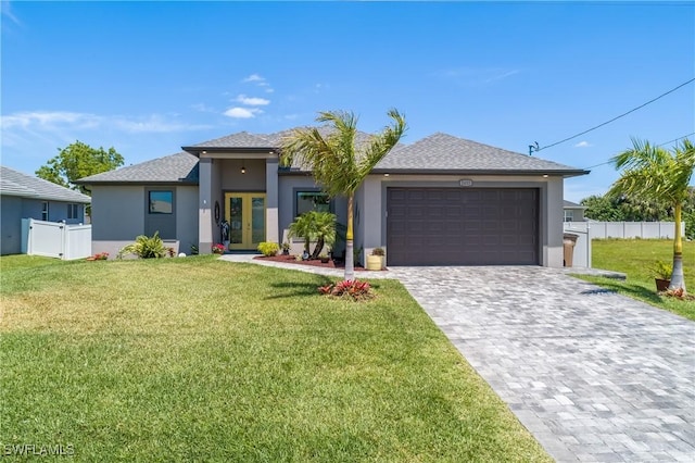 view of front of house with a front yard, french doors, and a garage