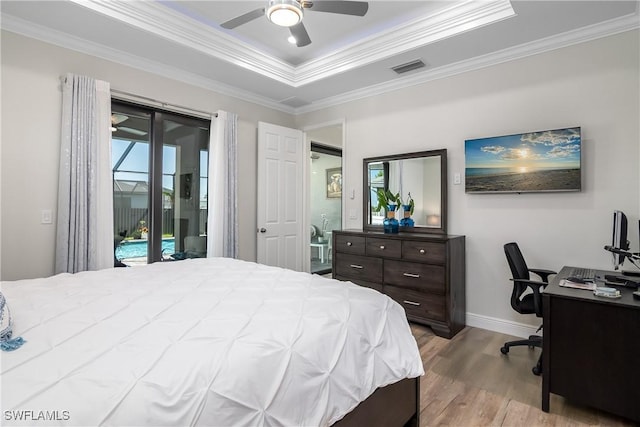 bedroom featuring access to exterior, a raised ceiling, ceiling fan, crown molding, and light hardwood / wood-style flooring