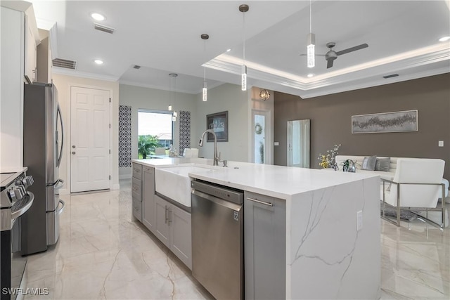 kitchen with pendant lighting, sink, ceiling fan, an island with sink, and stainless steel appliances