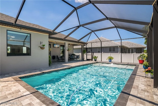 view of pool featuring a lanai, ceiling fan, and a patio