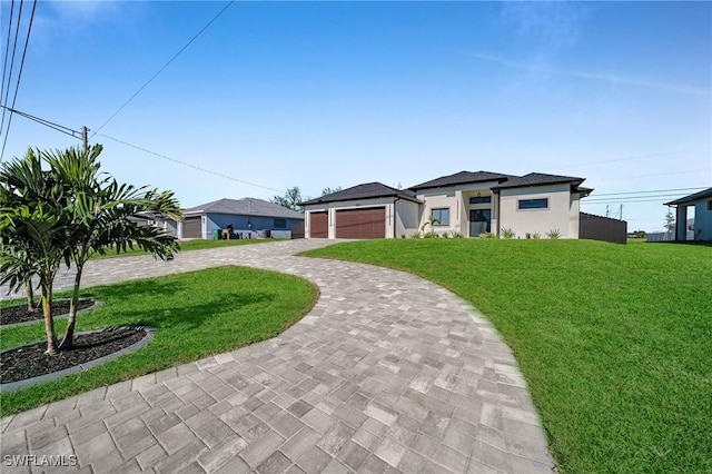 view of front of home with a front lawn and a garage