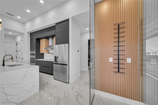 kitchen with sink, wall chimney range hood, and stainless steel appliances