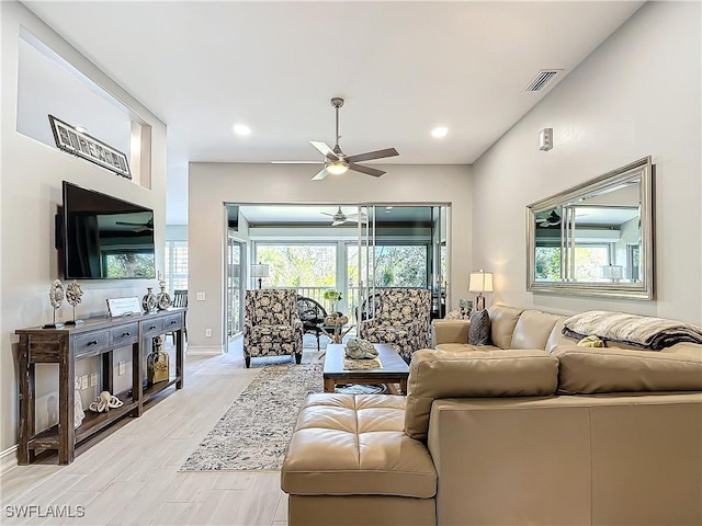 living room with ceiling fan and light wood-type flooring