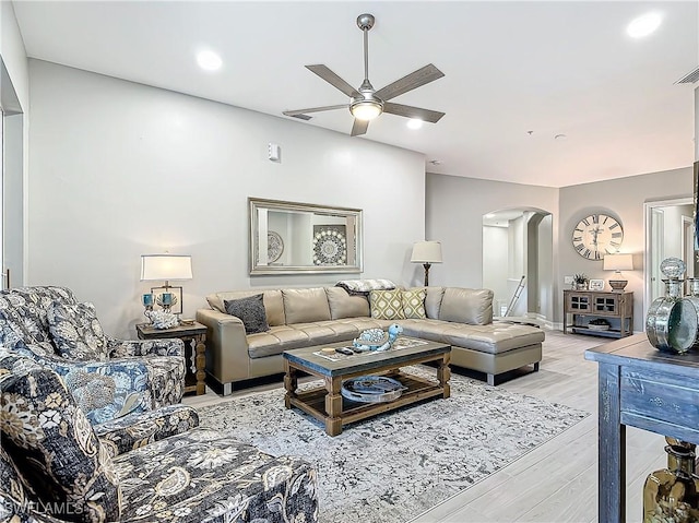 living room featuring light hardwood / wood-style floors and ceiling fan