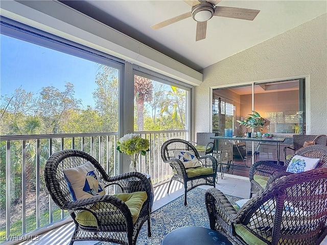 sunroom featuring ceiling fan and lofted ceiling