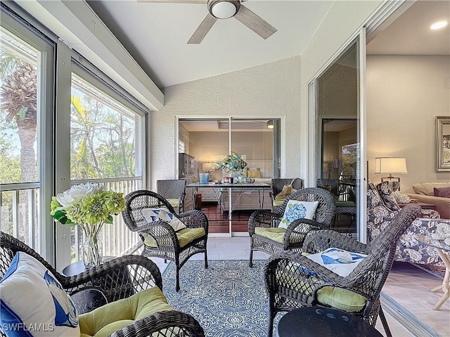 sunroom with ceiling fan and lofted ceiling