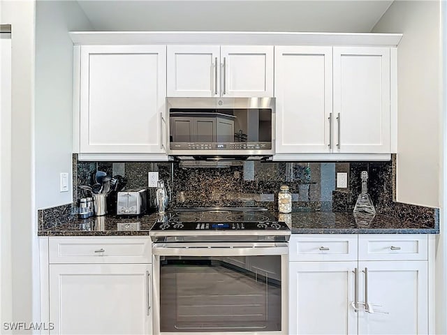 kitchen with appliances with stainless steel finishes, tasteful backsplash, and white cabinetry