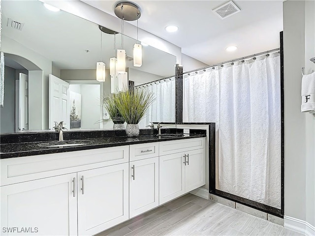 bathroom featuring vanity and wood-type flooring