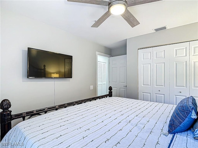 bedroom with ceiling fan and a closet