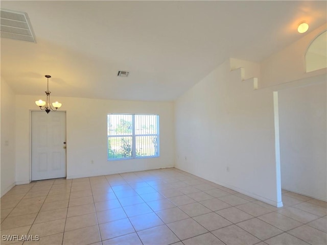 unfurnished room featuring light tile patterned flooring and an inviting chandelier