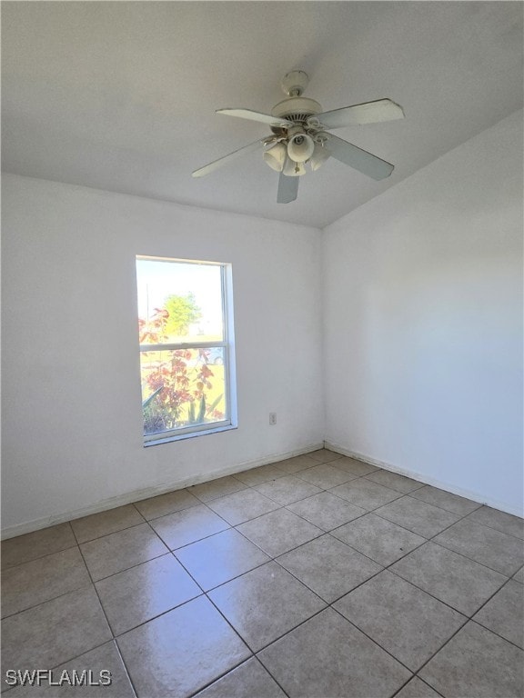 tiled empty room featuring ceiling fan