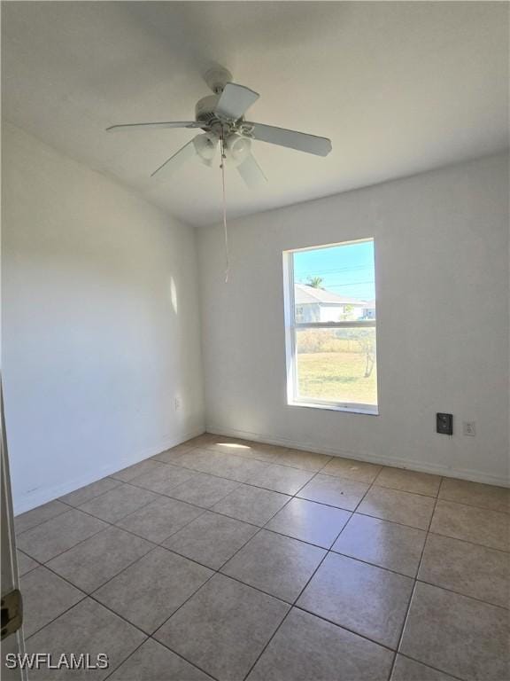 2419 NE 23rd Ave, Cape Coral, FL 33909 - spare room featuring tile patterned floors, a ceiling fan, and baseboards