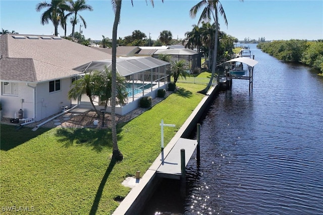 dock area with a water view, a lanai, and a lawn