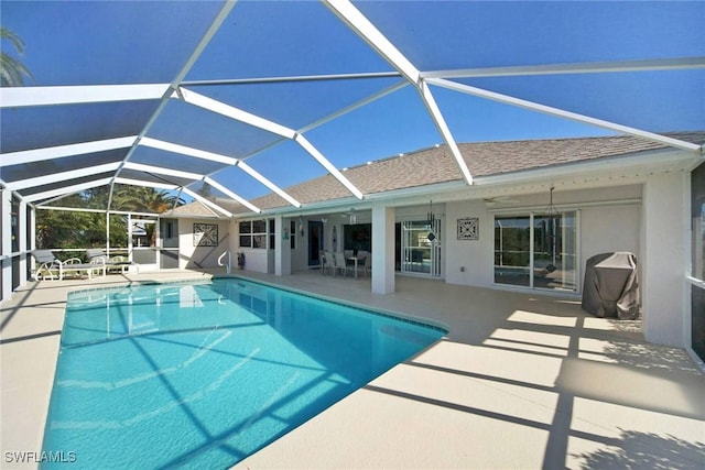 view of swimming pool with a lanai, a patio area, and ceiling fan