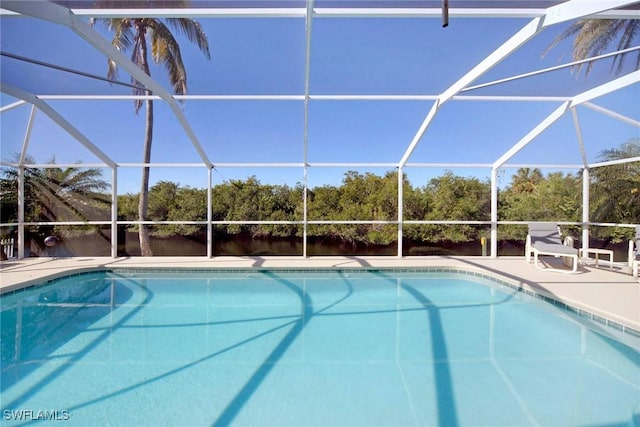 view of swimming pool with glass enclosure