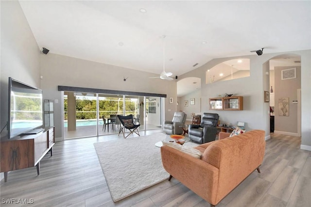 living room featuring ceiling fan, high vaulted ceiling, and light hardwood / wood-style floors