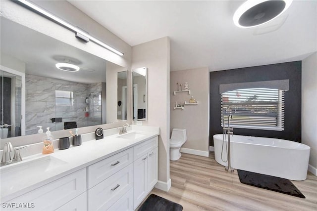 full bathroom with shower with separate bathtub, vanity, hardwood / wood-style flooring, and toilet