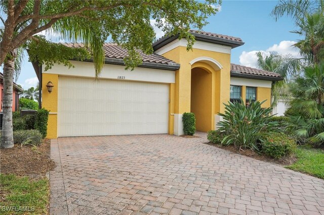 mediterranean / spanish-style house with a garage