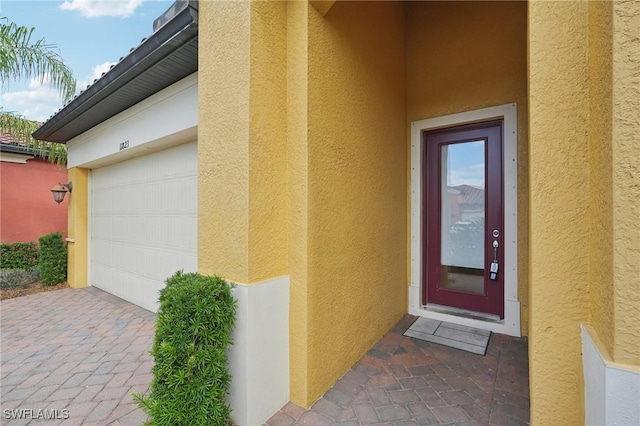 view of exterior entry featuring a garage