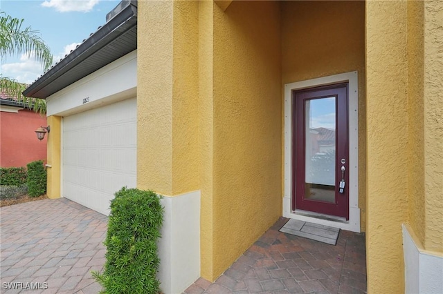 11823 Timbermarsh Ct, Fort Myers, FL 33913 - property entrance featuring stucco siding, a garage, and driveway