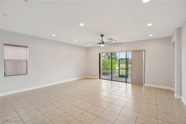 tiled spare room featuring ceiling fan