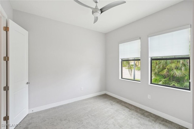 spare room with carpet floors and ceiling fan