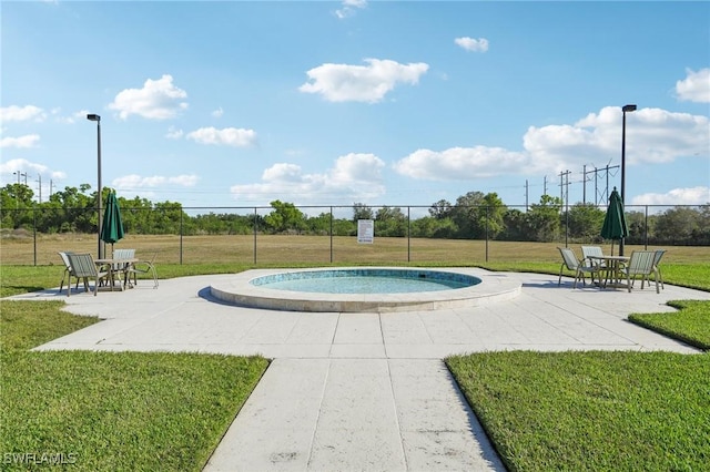 view of pool with a yard and a patio