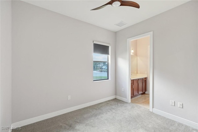 11823 Timbermarsh Ct, Fort Myers, FL 33913 - unfurnished bedroom with light colored carpet, baseboards, connected bathroom, and ceiling fan