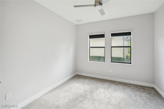 unfurnished room with ceiling fan and light carpet