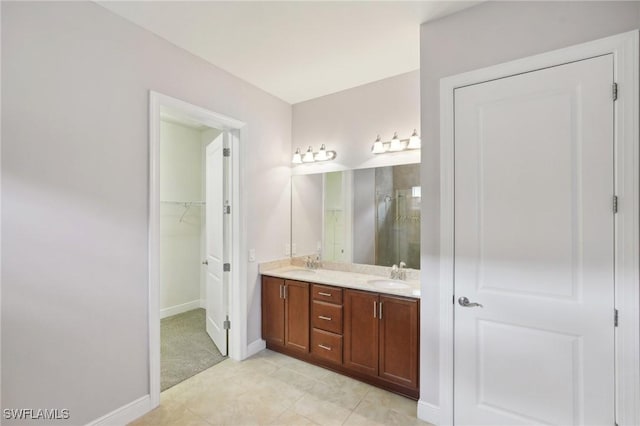 11823 Timbermarsh Ct, Fort Myers, FL 33913 - bathroom featuring double vanity, a shower stall, a walk in closet, baseboards, and tile patterned floors