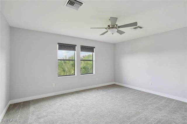 spare room featuring ceiling fan and carpet flooring