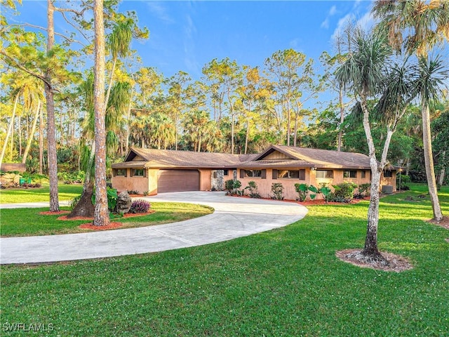 view of front of property with a front yard and a garage