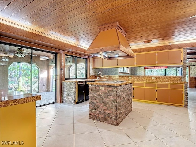 kitchen featuring custom exhaust hood, plenty of natural light, and wooden ceiling