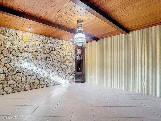 spare room featuring beamed ceiling, light tile patterned floors, and wood ceiling